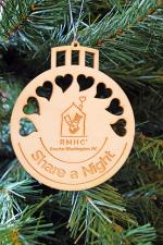 Product Description: One Ornament = One Night</br></br>This locally handcrafted wooden ornament is beautifully made to include heart cut-outs that allow the light to show through and is engraved with the RMHCDC logo and "Share A Night." </br></br>Each ornament purchased sponsors a one-night stay for a family at one of our Ronald McDonald Houses. They make thoughtful gifts for friend, family, teachers, and neighbors while giving back to families in need!</br></br>Pro tip: The wooden design allows you to customize the ornament to give as a special gift. You can paint it, write on it with a marker, or glue pictures on. Get creative and share your pictures on social media with the hashtags #ShareANight #RMHCDC #KeepingFamiliesClose. We can't wait to see what you do!</br> 2019 Share A Night Ornament